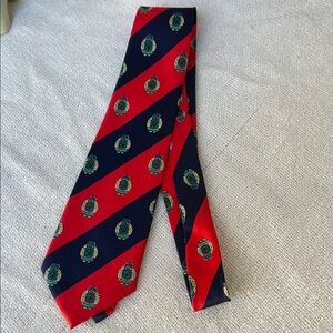 Elegant Red and Blue Striped Silk Tie with Crest Design